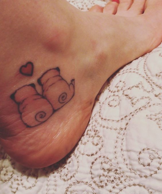 outline of two sitting Pugs Tattoo on heel