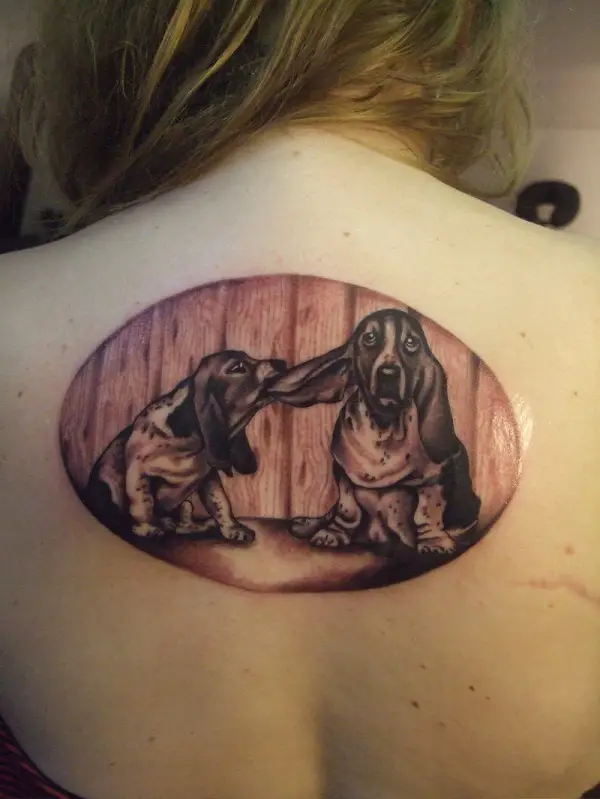 Basset Hound dog pulling the ears of another Basset Hound Tattoo on the back