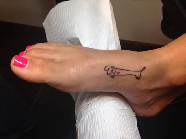 small outline of a Dachshund tattoo on the feet