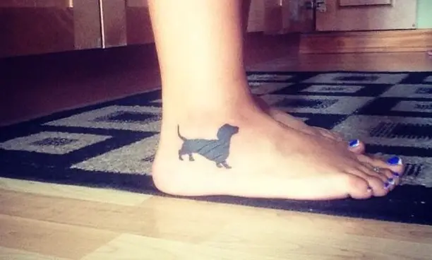 plain black Dachshund character tattoo on the ankle