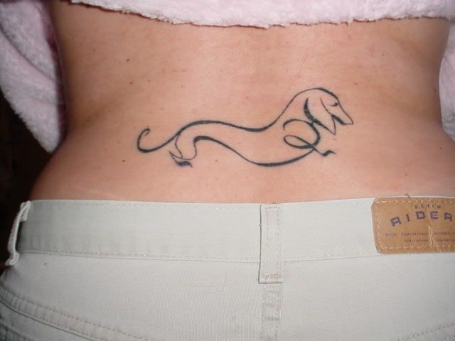outline of a Dachshund tattoo on the lower back