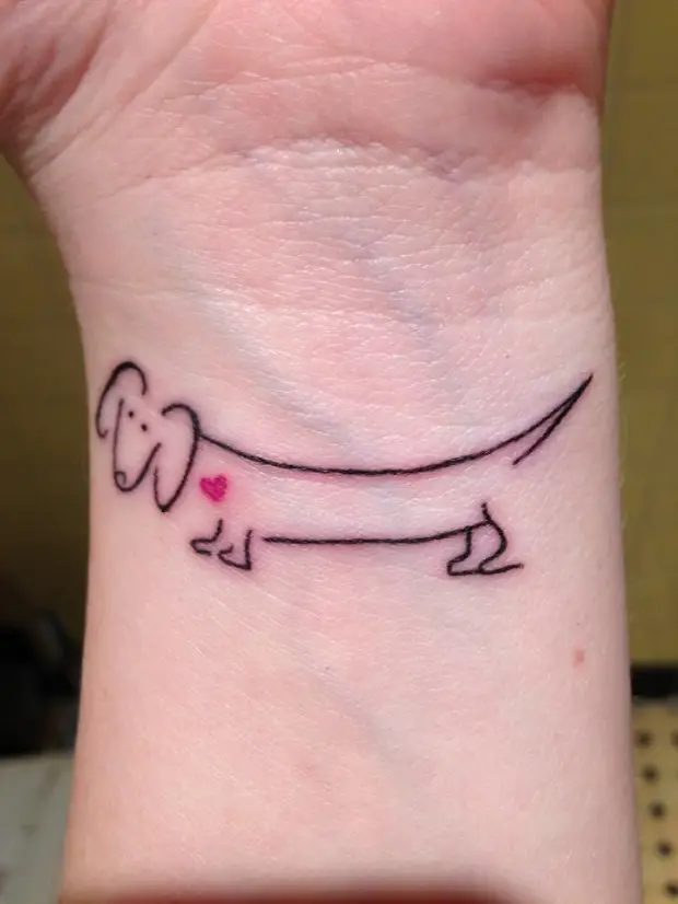 outline of a Dachshund tattoo on the wrist