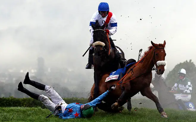 a horse dragging its fallen rider