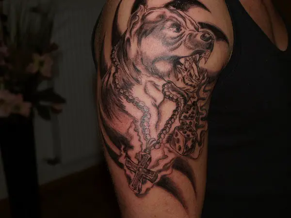 A black and gray angry sideview face of Pit Bull tattoo on the shoulder