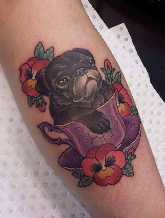 Pug in teacup with flowers around Tattoo on forearm