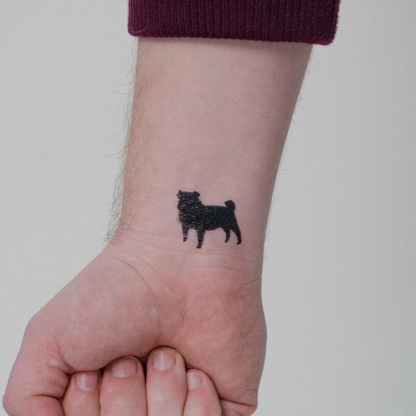 minimalist black Pug Tattoo on wrist