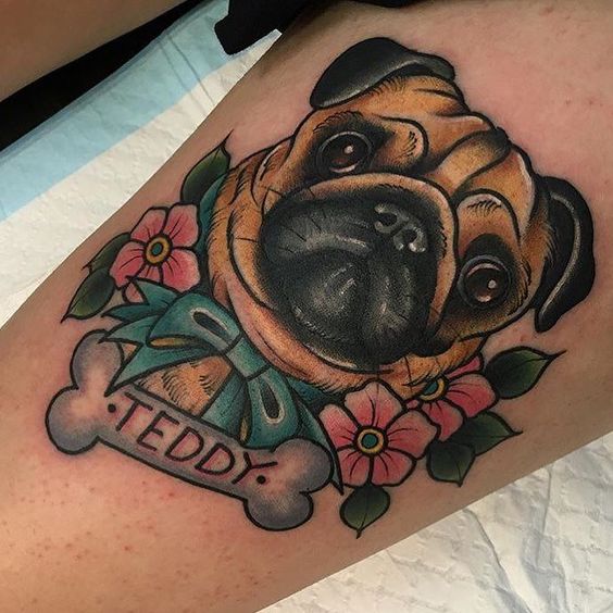 3D face of pug with flowers and bone with name tattoo on the leg