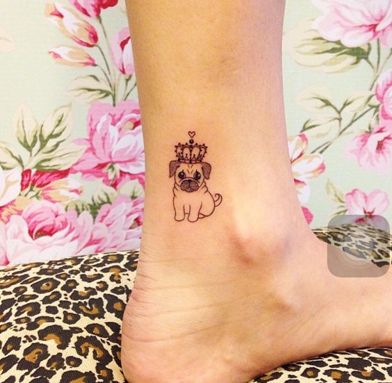 small pug wearing a crown tattoo on the ankle