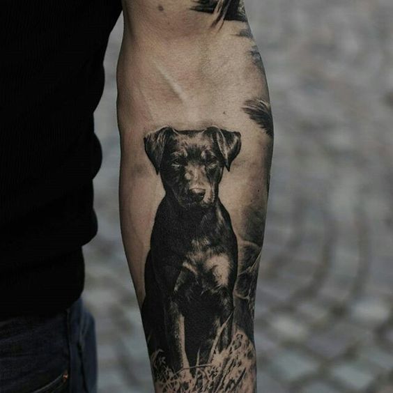 Labrador sitting on the grass tattoo on the forearm