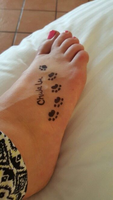 five paw prints with name chulalu tattoo on the foot of a woman