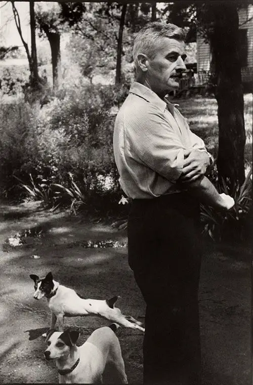 William Faulkner outdoors with his two Jack Russell Terriers