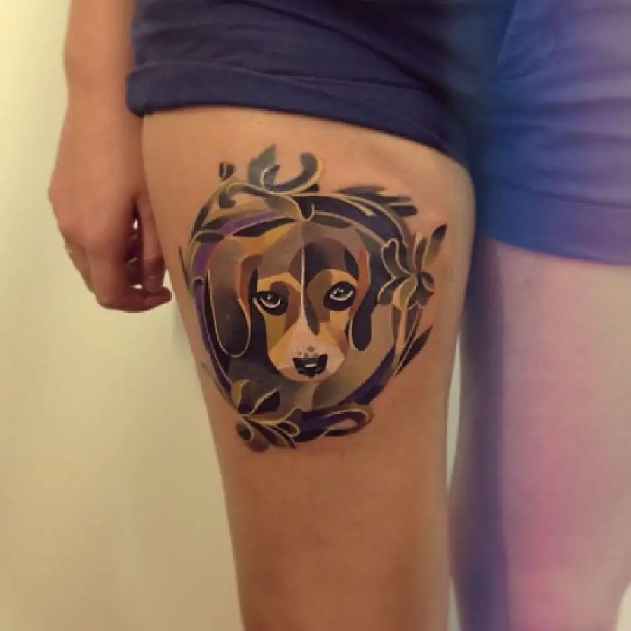 neutral colored face of Beagle with leaves around it Tattoo on thighs