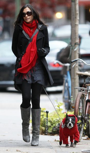 Famke Janssen walking in the street with her Boston Terrier wearing its winter clothes