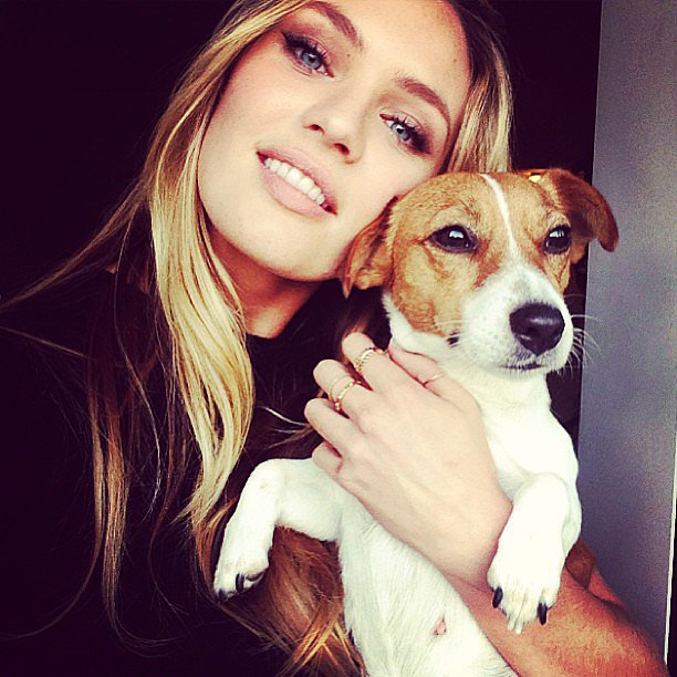 Candice Swanepoel taking a selfie with her Jack Russell Terrier