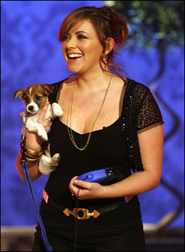 Charlotte Church on the stage carrying her Jack Russell Terrier puppy