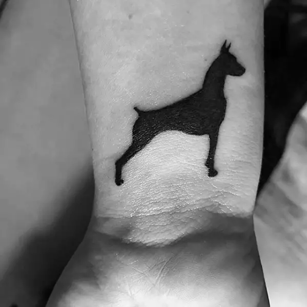 silhouette of a standing Doberman small tattoo on the wrist