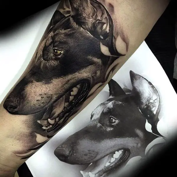 black and gray sideview face of Doberman 3D tattoo on the forearm