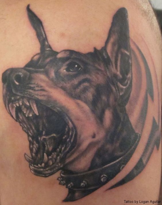 an angry face of a Doberman with its mouth wide open and showing its fangs tattoo