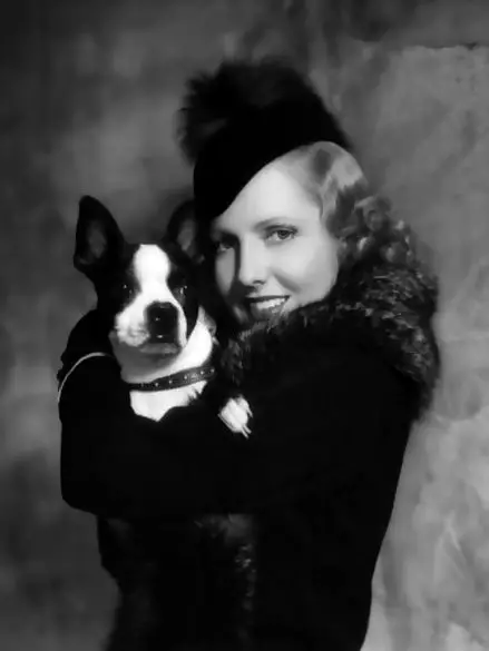 Jean Arthur hugging her Boston Terrier