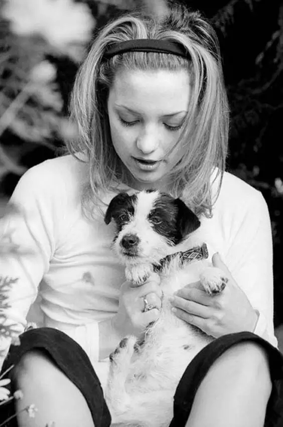 black and white photo of Kate Hudson holding her Jack Russell Terrier puppy in her lap