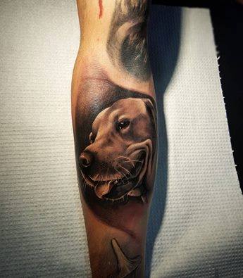 3D smiling face of a Labrador tattoo on the forearm