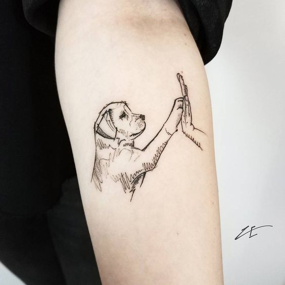 Labrador giving a high-five sketch style tattoo on the forearm