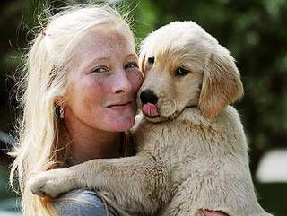Maggie Rizer holding her Golden Retriever puppy