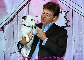 Paul McCartney talking to his Jack Russell Terrier in his arms