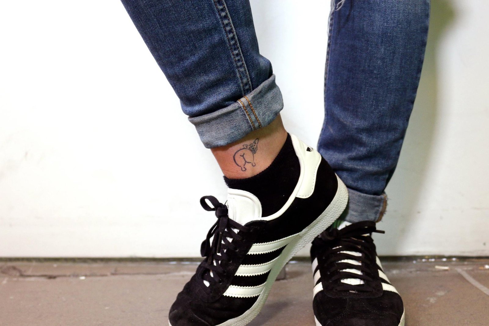 corgi butt tattoo on the ankle of a woman