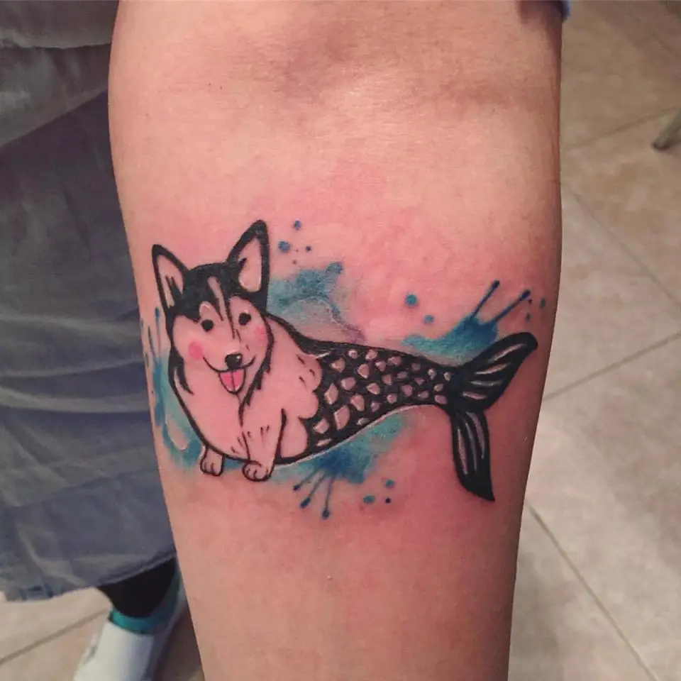 a mermaid corgi in the water tattoo on the forearm