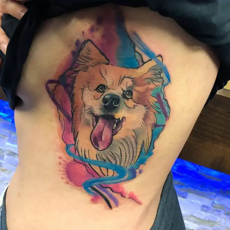 a corgi with blue and red background tattoo on the side of the girls body