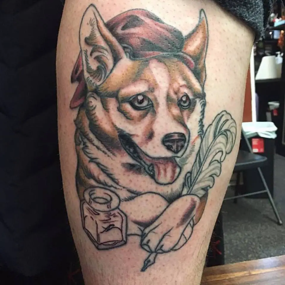 a writer corgi tattoo on the leg
