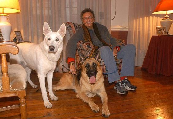 Pepito Cibrian in the living room with his two German Shepherds