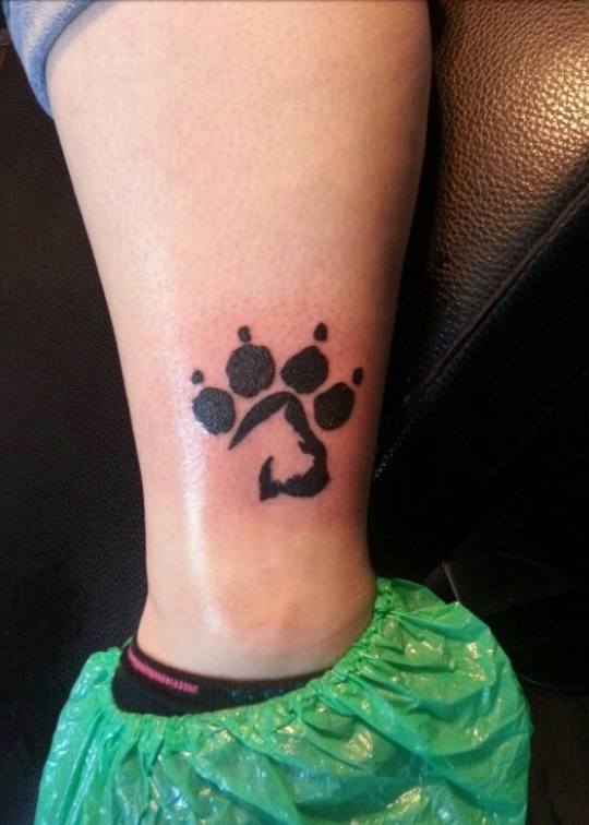 paw print with sideview shape of Schnauzer tattoo on the ankle