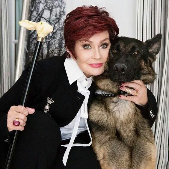 Sharon Osbourne hugging her German Shepherd