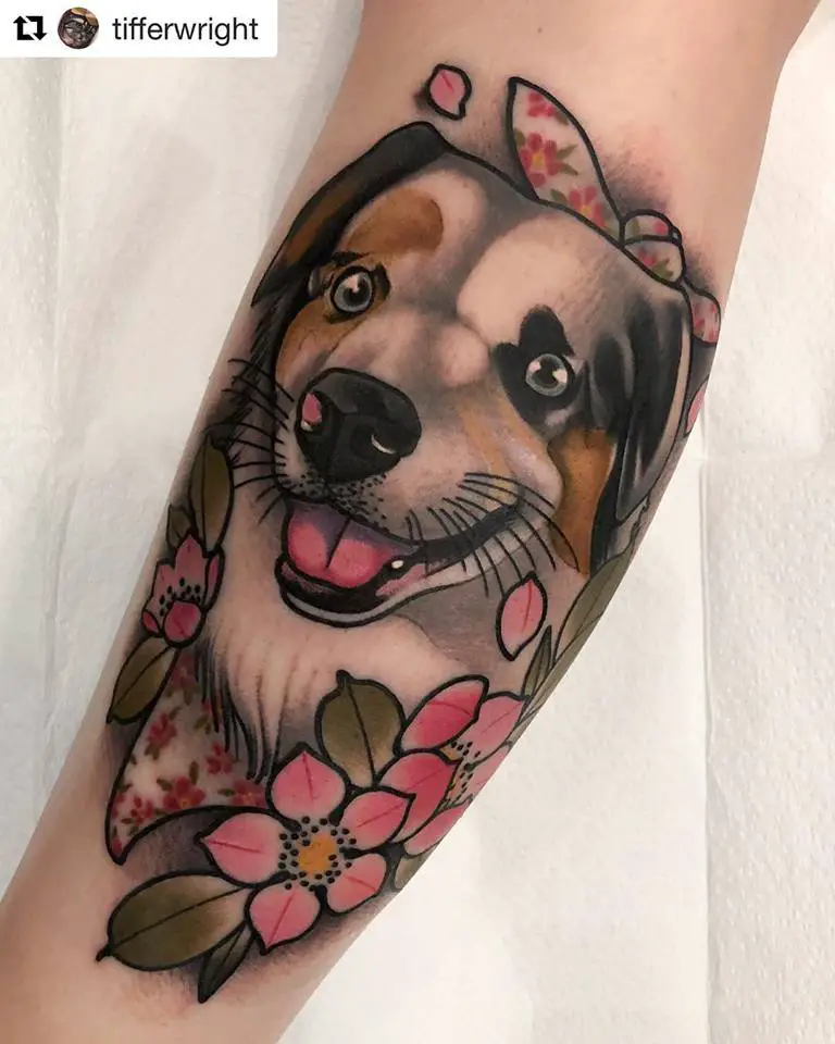 animated smiling face of a Australian Shepherd Dog with black, gray, and brown colors, and with pink flowers on its neck tattoo on the leg