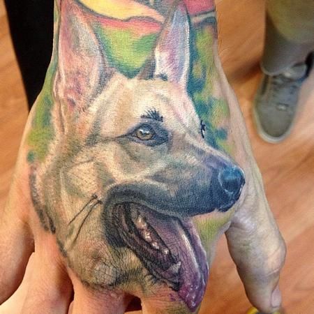 German Shepherd Dog with its tongue sticking out Tattoo on the hand