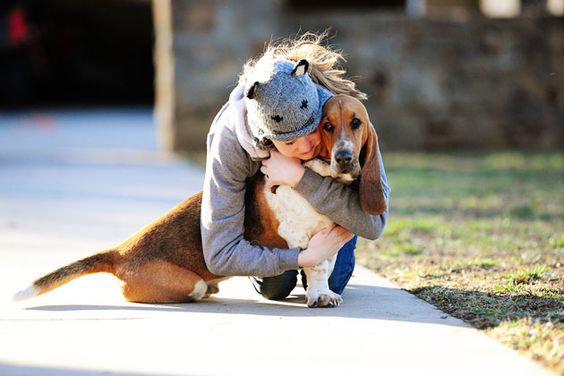 girl hugging a Basset hound