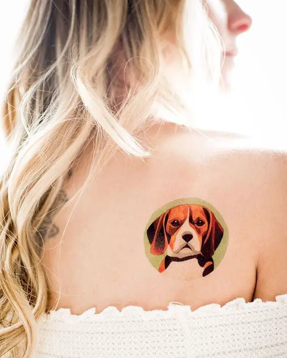 animated face Beagle inside a green circle tattoo on the back