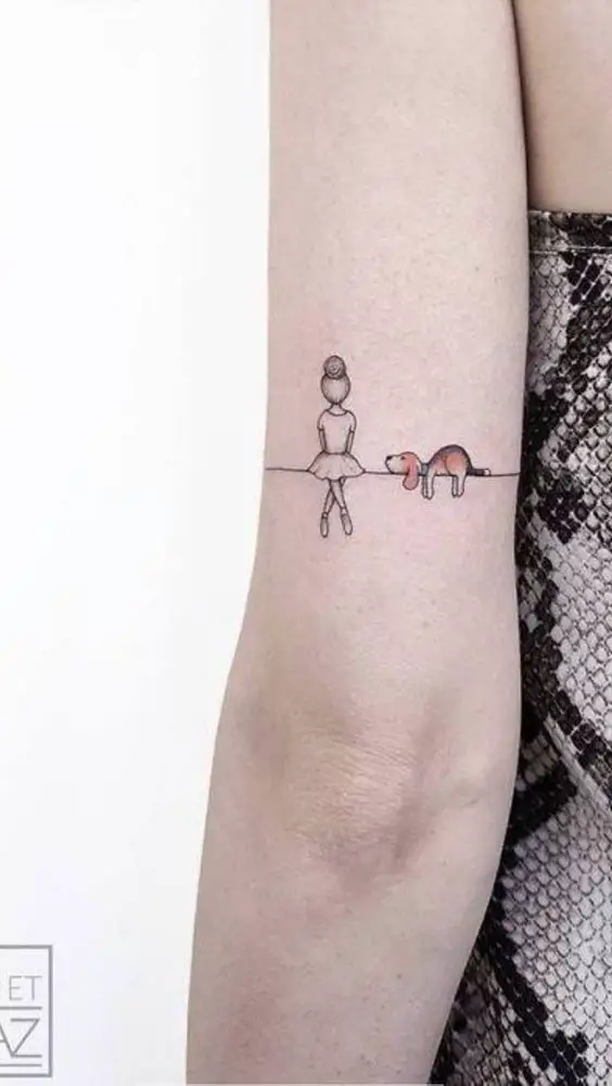 lying down Beagle with a girl sitting beside it tattoo on arms