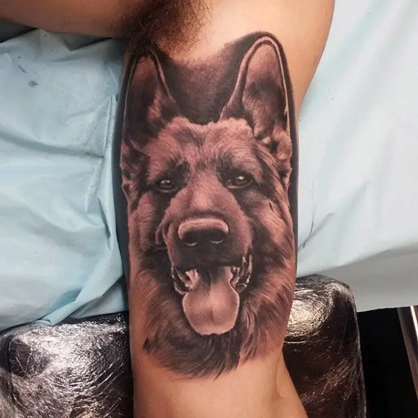 3D German Shepherd Dog with its tongue sticking out tattoo on the biceps