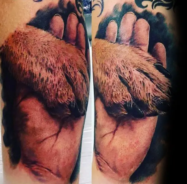 hand holding a paw 3D tattoo