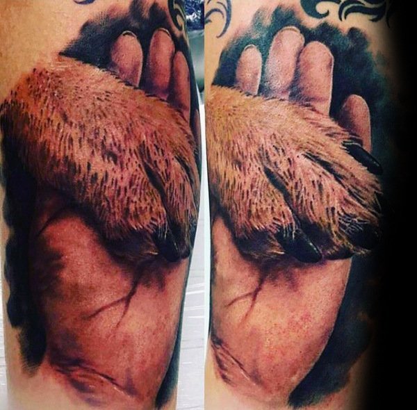 hand holding a paw 3D tattoo