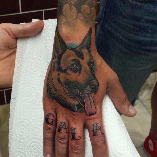 German Shepherd Dog with its tongue out Tattoo on the hand