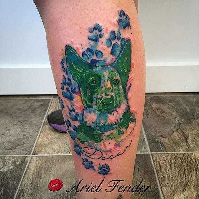 green German Shepherd Dog with blue paws and name