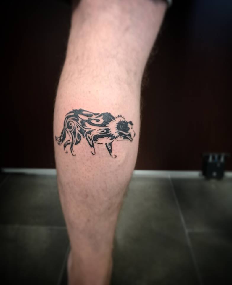 tribal Border Collie tattoo on the leg