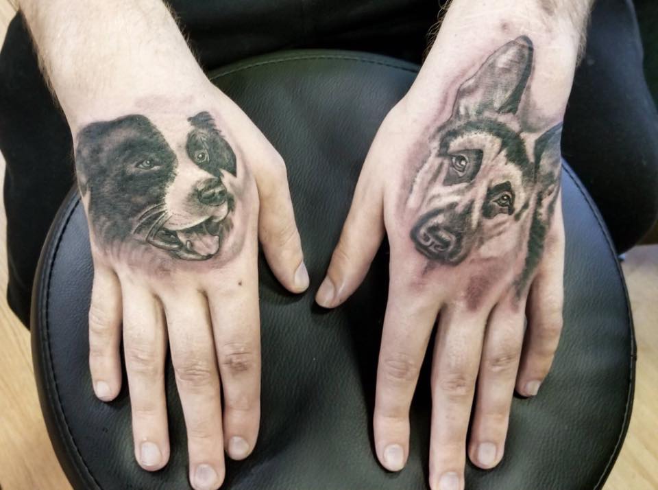 face of a Border Collie tattoo in the hand of woman