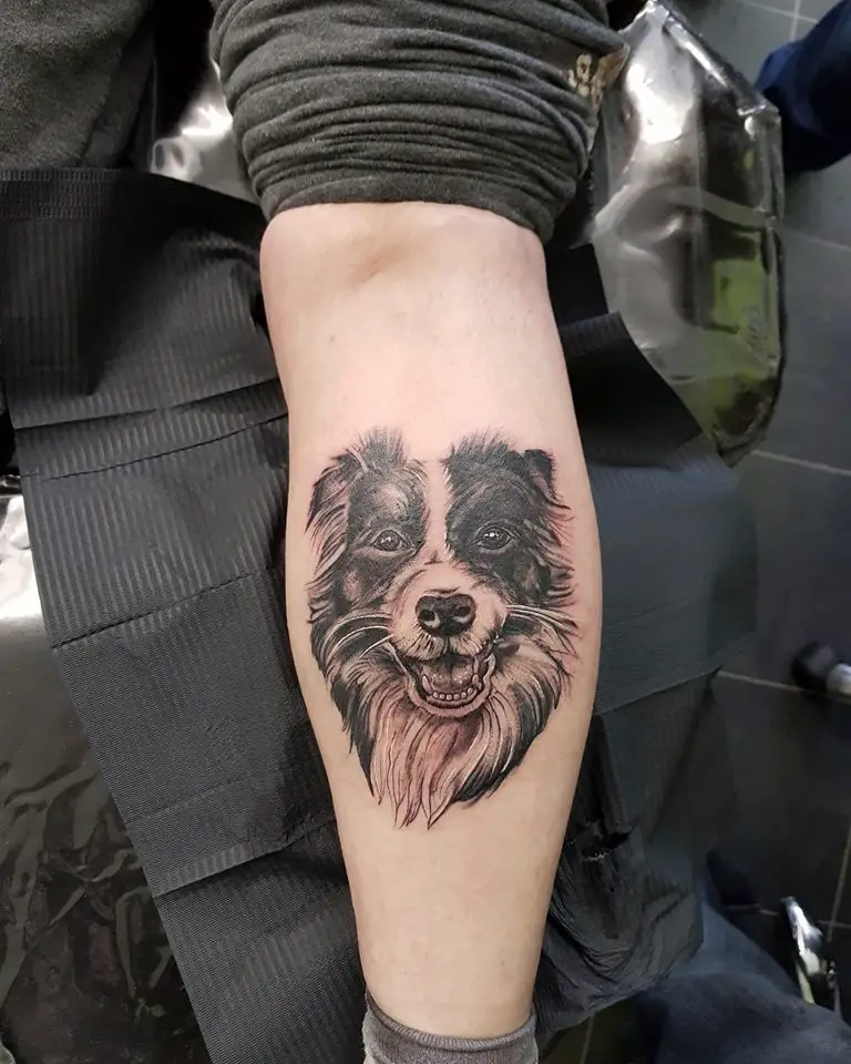 a happy face of a Border Collie tattoo on the forearm