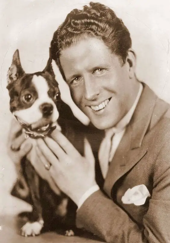 Rudy Valee holding his Boston Terrier