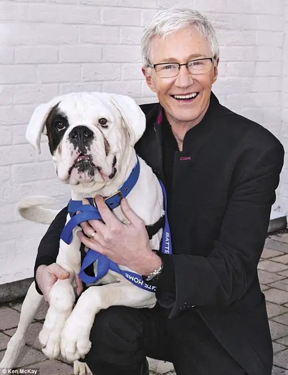 Paul O’Grady with his Boxer dog in his lap